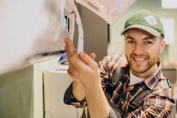 HVAC technician performing maintenance on an HVAC system to ensure optimal performance and energy efficiency.
