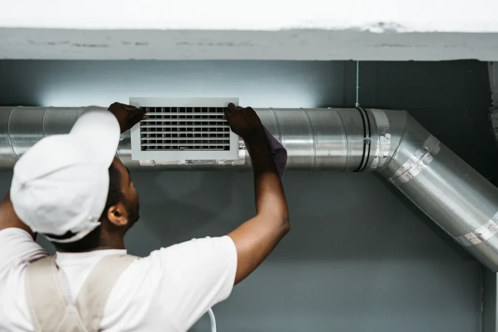 Technician installing a vent for an energy-efficient HVAC system.