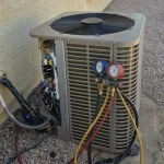 HVAC unit undergoing maintenance with pressure gauges attached for diagnostics.