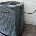 Outdoor Trane HVAC unit installed beside a residential wall.