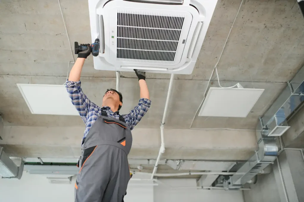 Technician inspecting a heater for common issues like inconsistent heating and unusual noises.