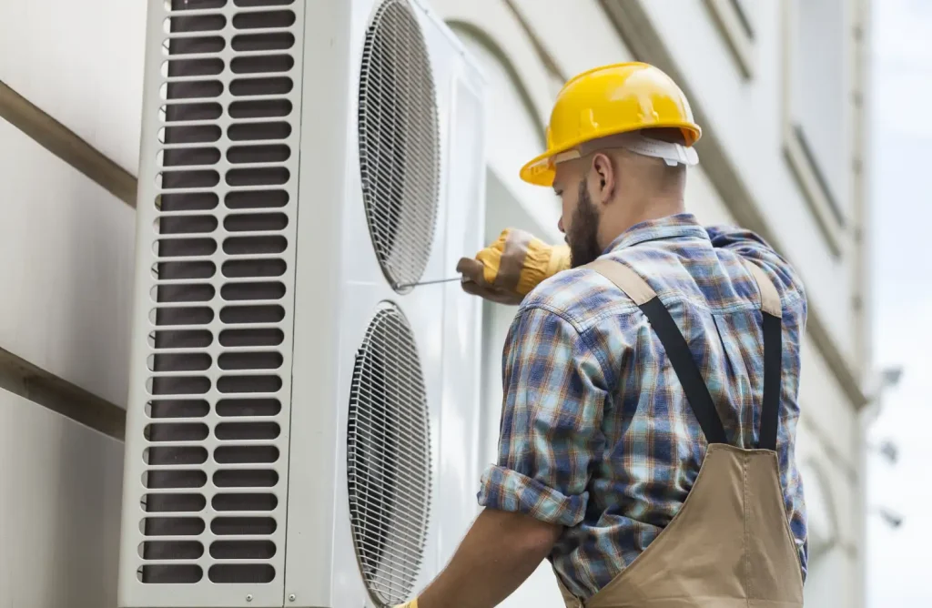 24 hour AC service technician repairing an outdoor unit.