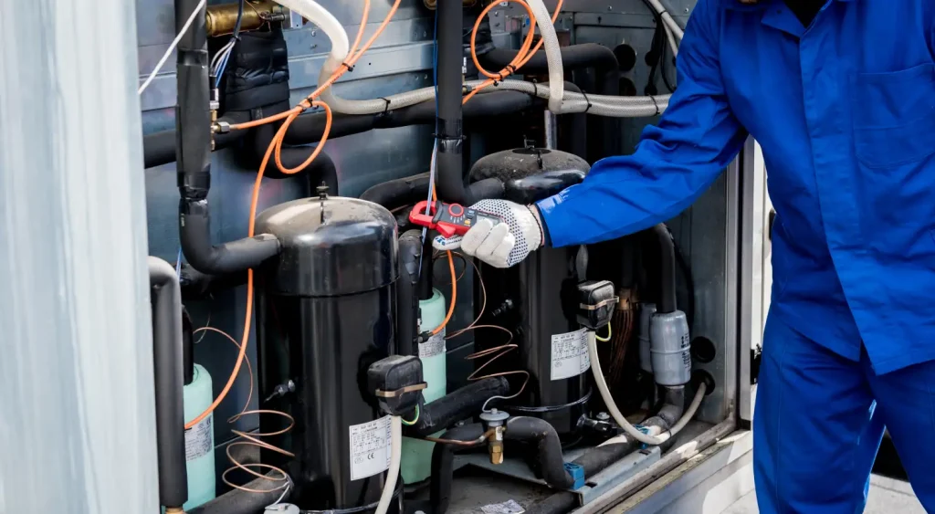 Technician performing regular AC repair on a commercial cooling unit.