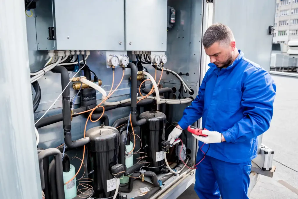 Technician performing 24 hour AC service on a commercial cooling system.